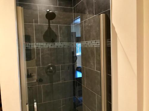 a shower in a bathroom with a glass door at Cozy private Guest House in Los Angeles