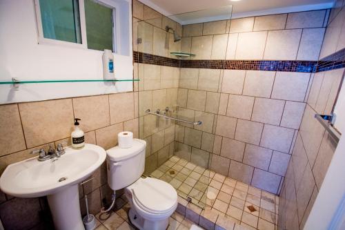 a bathroom with a toilet and a sink at Beachfront, sun, sand & fun - Cozy 1 Bdr Apt in Tijuana