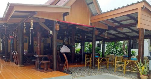 a pavilion with tables and chairs in a restaurant at Lanta Blue House in Ko Lanta