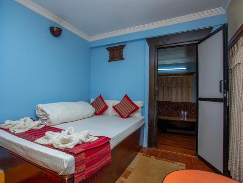 a room with a bed with a blue wall at Kathmandu Boutique Hotel in Kathmandu