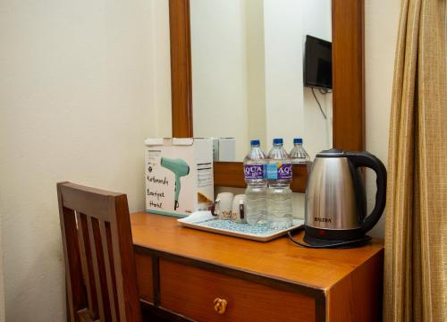 a table with a box and water bottles on it at Kathmandu Boutique Hotel in Kathmandu