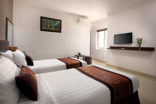 Postel nebo postele na pokoji v ubytování Nolis Hotel