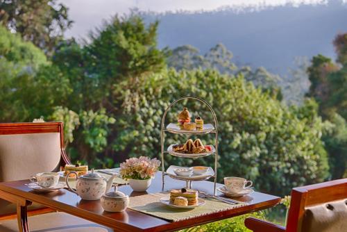 a table with a plate of food on top at Jetwing Oatlands Bungalow in Nuwara Eliya