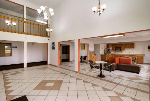 an open living room with a table and chairs at Motel 6-Davenport, IA in Davenport