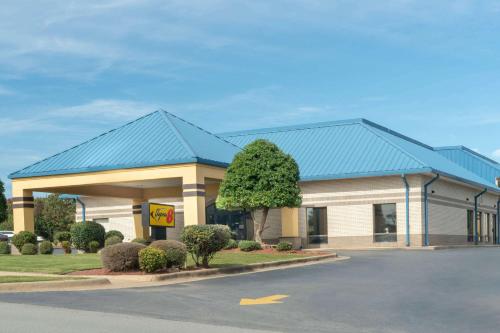 a large convenience store with a blue roof at Super 8 by Wyndham North Little Rock/McCain in North Little Rock