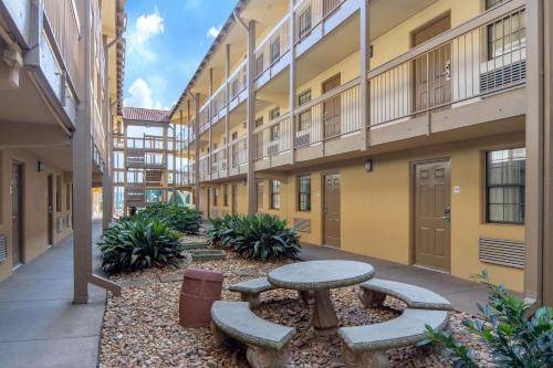 a courtyard with a table and benches in front of a building at Budget Inn & Suite Atlanta Marietta Stadium in Marietta