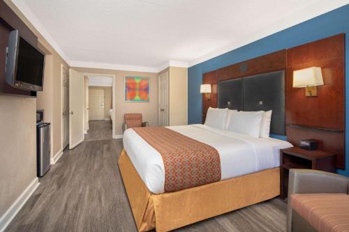 a hotel room with a large bed and a television at Budget Inn & Suite Atlanta Marietta Stadium in Marietta