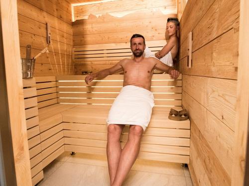 a man and a woman in a sauna at Apartment Sella in Siusi