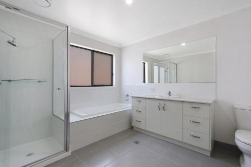 a bathroom with a shower and a toilet and a sink at BrightAway in Bright