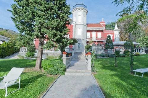 a house with a tower on top of it at Residence Villa Bottacin in Trieste