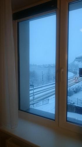 a window with a view of a snowy highway at Appartement Alpensee in Zell am See