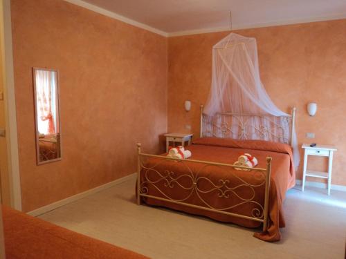 a bedroom with a bed with a canopy at Bed&Breakfast Giardini di Corte in Toscolano Maderno