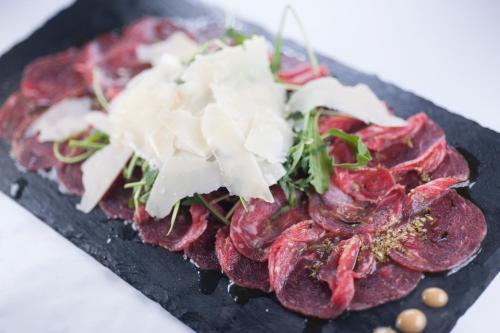 a plate of food with meat and cheese on it at Hotel Moskva in Budva