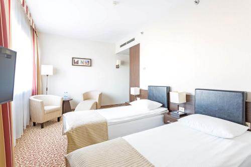 Postel nebo postele na pokoji v ubytování Qubus Hotel Łódź