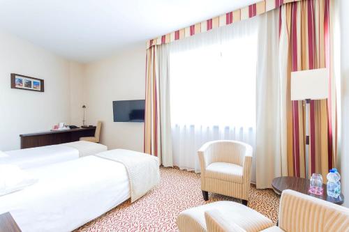 Postel nebo postele na pokoji v ubytování Qubus Hotel Łódź