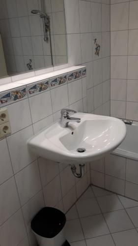 a bathroom with a white sink and a toilet at A&M-Wohnen in Ravensburg