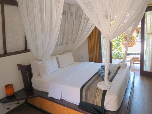 Postel nebo postele na pokoji v ubytování Gili Air Bungalows