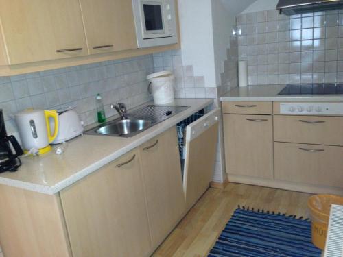 a small kitchen with a sink and a counter at Ferienwohnung Moritz in Kaunertal