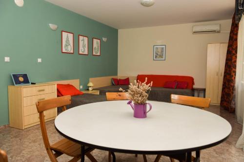 a living room with a table and a couch at Comfort Apartment in Pomorie