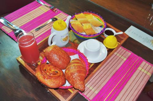 a tray with pastries and a drink on a table at Anouk Hotel in Antananarivo
