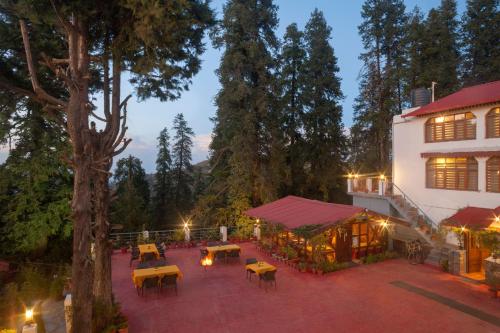 an overhead view of a patio with tables and a building at The Hermitage Kanatal in Kanatal