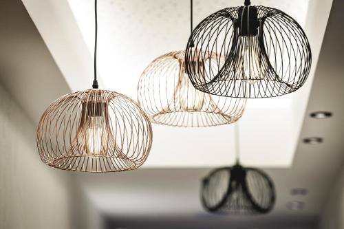 three lights are hanging from the ceiling in a room at Alpinlounge Rätia Appartements in Ischgl