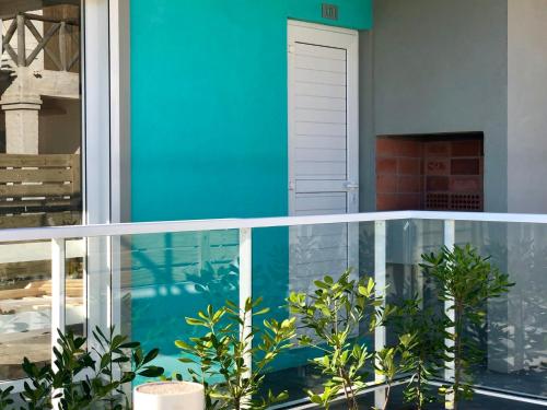 a balcony with a blue wall and some plants at Las Olas Aparts in La Paloma