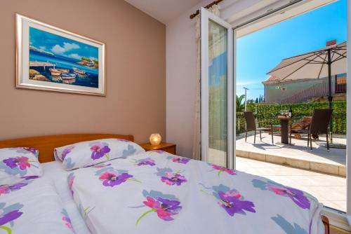 a bedroom with a bed and a large window at Villa Adria in Cavtat