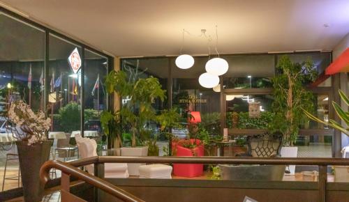 a restaurant with plants in the window of a store at Hotel Valpolicella International in San Pietro in Cariano