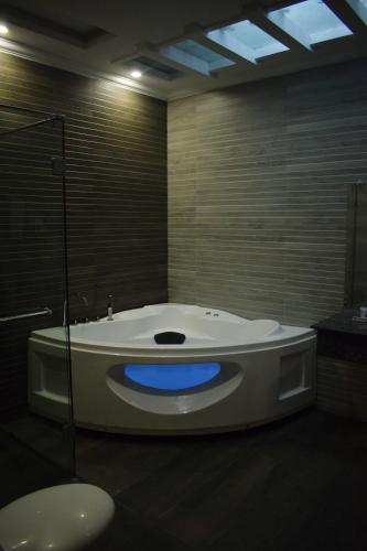 a bathroom with a tub with a blue light at Grand Millennium Hotel in Lahore