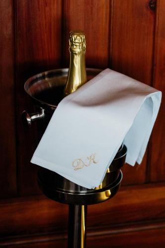 a table with a napkin and a bottle of champagne at Hotel & Restaurant "Deutscher Kaiser" in Perleberg