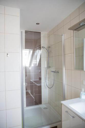 a shower with a glass door in a bathroom at Buschenschank Ofnerpeter in Sankt Stefan ob Stainz