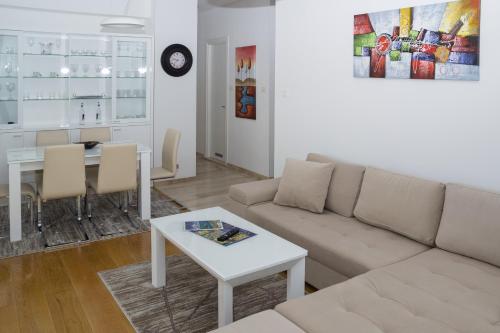 a living room with a couch and a table at Apartments Menuet in Budva