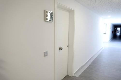 an empty hallway with a white door in a building at Luxury apartment in Playa Paraiso in Playa Paraiso