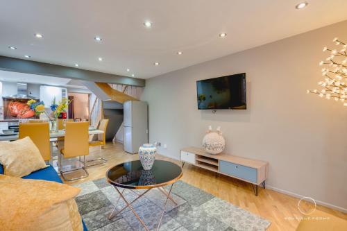 a living room with a couch and a table at The Retreat Sauna & Hot Tub Boutique Rooms in Great Paxton