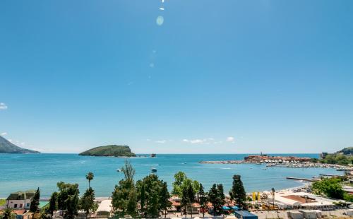 a view of a beach and the ocean at Apartments Menuet in Budva
