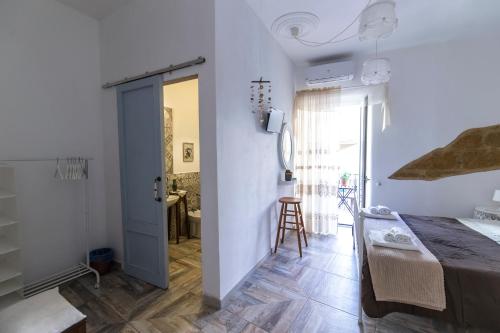 a bedroom with a bed and a sliding door at Zabbara in Agrigento