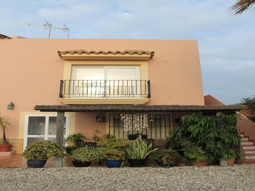 a house with a balcony and a bunch of plants at Apartamento La Torre in El Palmar