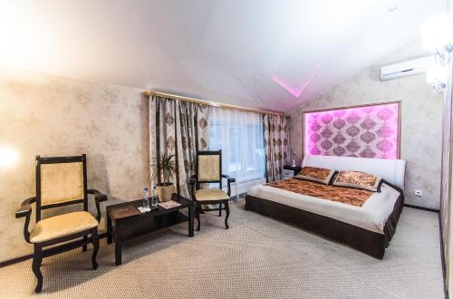 イヴァノヴォにあるHotel Raiのベッドルーム1室(ベッド1台、テーブル、椅子付)