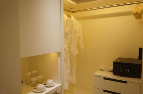 a bathroom with a white robe hanging on a wall at The Pier Hotel in Hong Kong