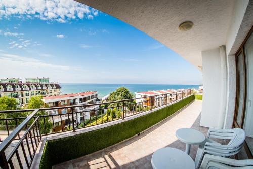 a balcony with chairs and a view of the ocean at Messambria Fort Noks Beach Apartments in Elenite