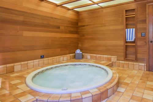 a jacuzzi tub in a room with wooden walls at Skyland Retreat - Max nighttime occupancy of 8 in Zephyr Cove