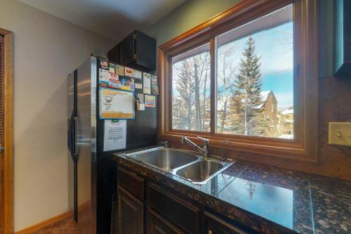 a kitchen with a sink and a refrigerator and a window at Rivercrest 1 in Frisco