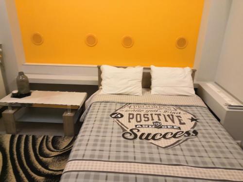 Cette petite chambre comprend un lit avec une tête de lit jaune. dans l'établissement Barbara's appartment, à Athènes