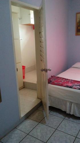 a room with a door open to a bedroom with a bed at Don Santiago Guesthouse Downtown in San Ignacio