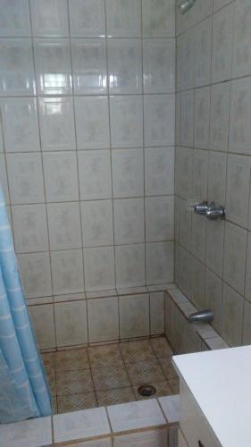 a bathroom with a shower with a drain at Don Santiago Guesthouse Downtown in San Ignacio