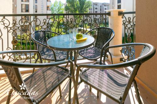 a table and four chairs on a balcony at Cascadas Family Resort in Sunny Beach
