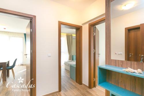a bathroom with a blue counter and a mirror at Cascadas Family Resort in Sunny Beach