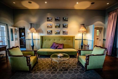 a living room with a couch and two chairs at The Royal Hotel in Riebeek-Kasteel