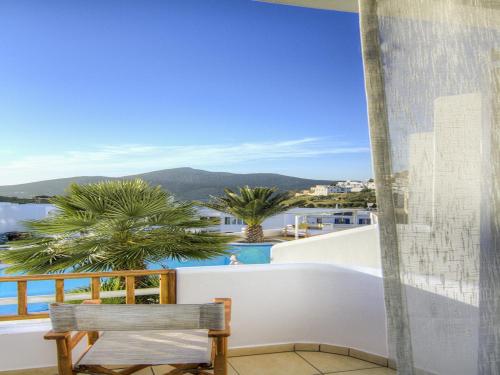 a balcony with a bench and a view of the water at Avanti in Ios Chora